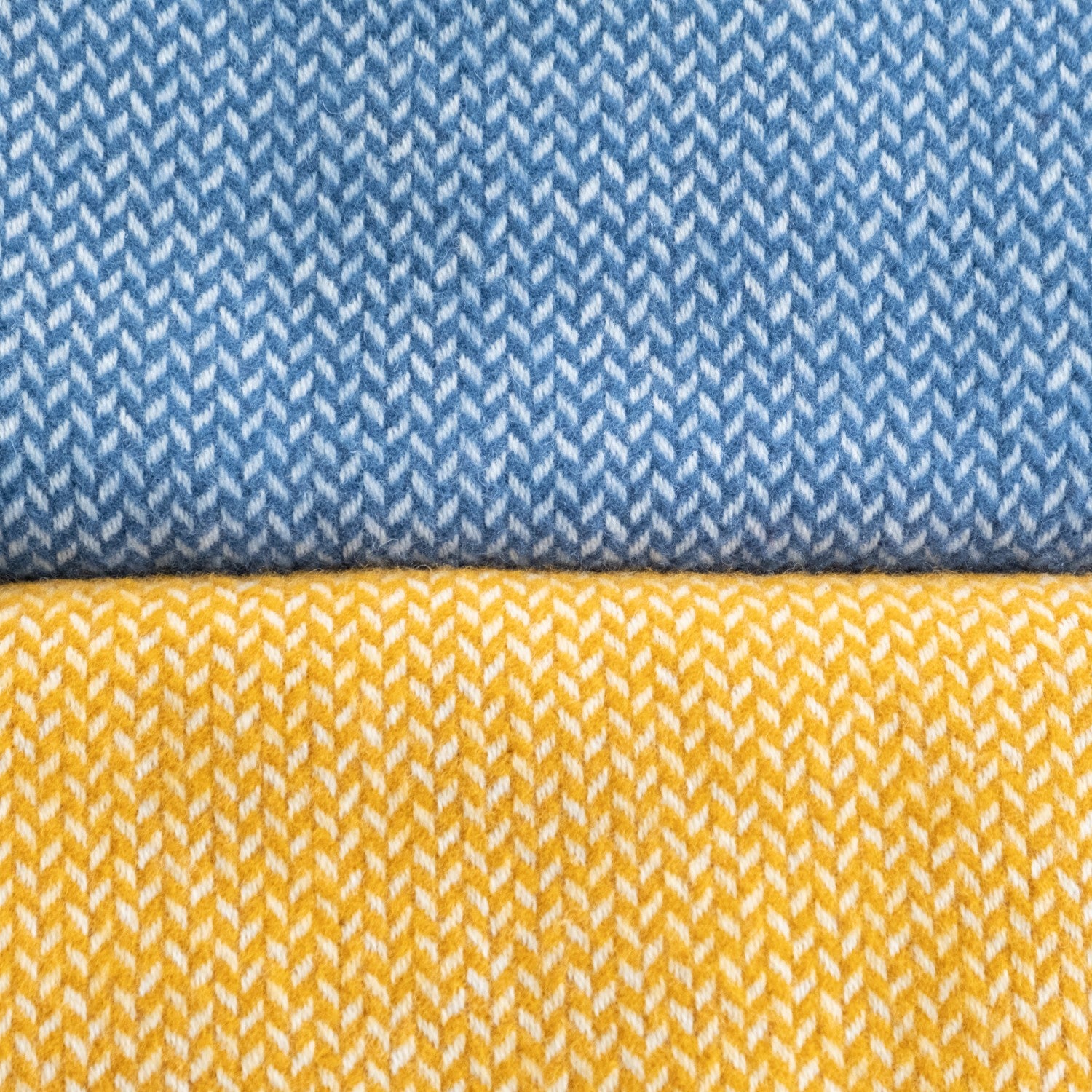 Close-up of blue and yellow patterned fabric, showcasing intricate textile design, commonly used in clothing and fashion design.