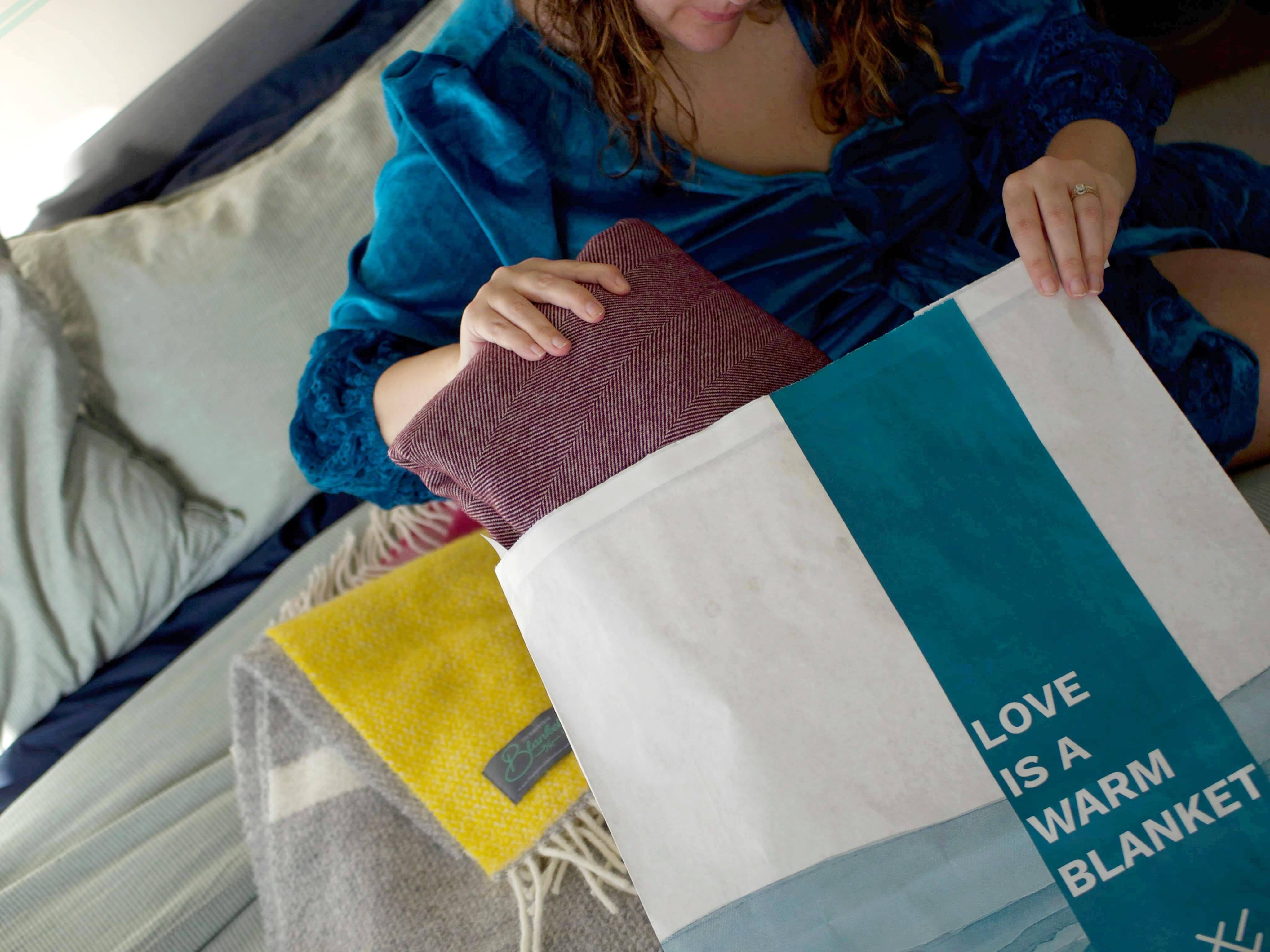 A woman opening a parcel in eco friendly packaging