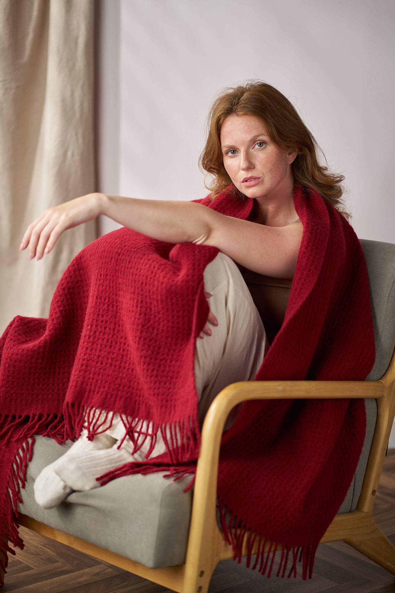 Red waffle wool blanket woman on chair