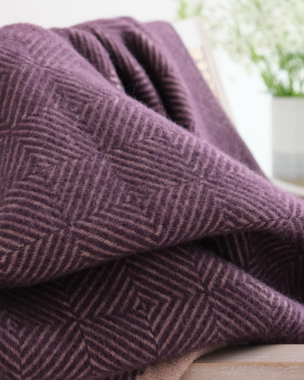 purple wildweave wool blanket on a chair