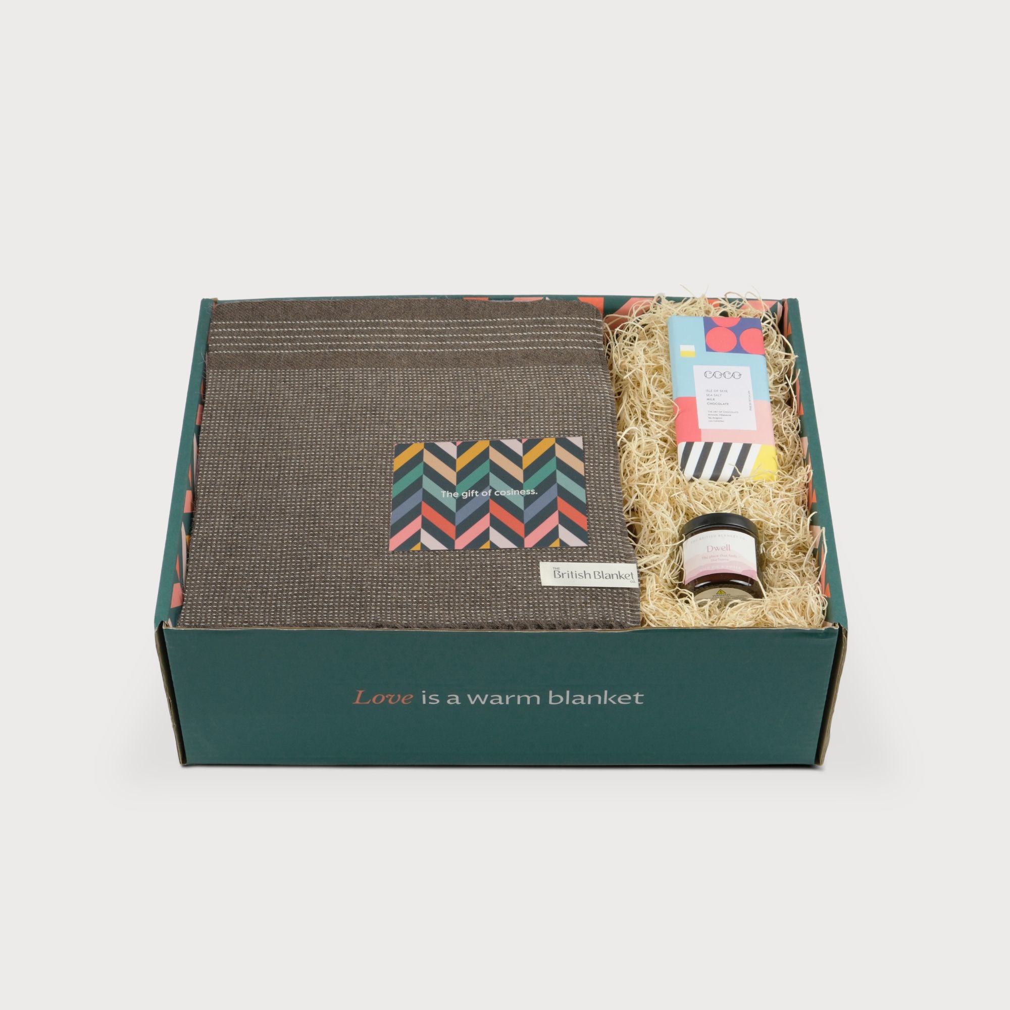 Alpaca Blanket Gift Box: Mocha Brown featuring a woven blanket, greeting card, amber jar candle, and sea salt chocolate bar in eco-friendly packaging.