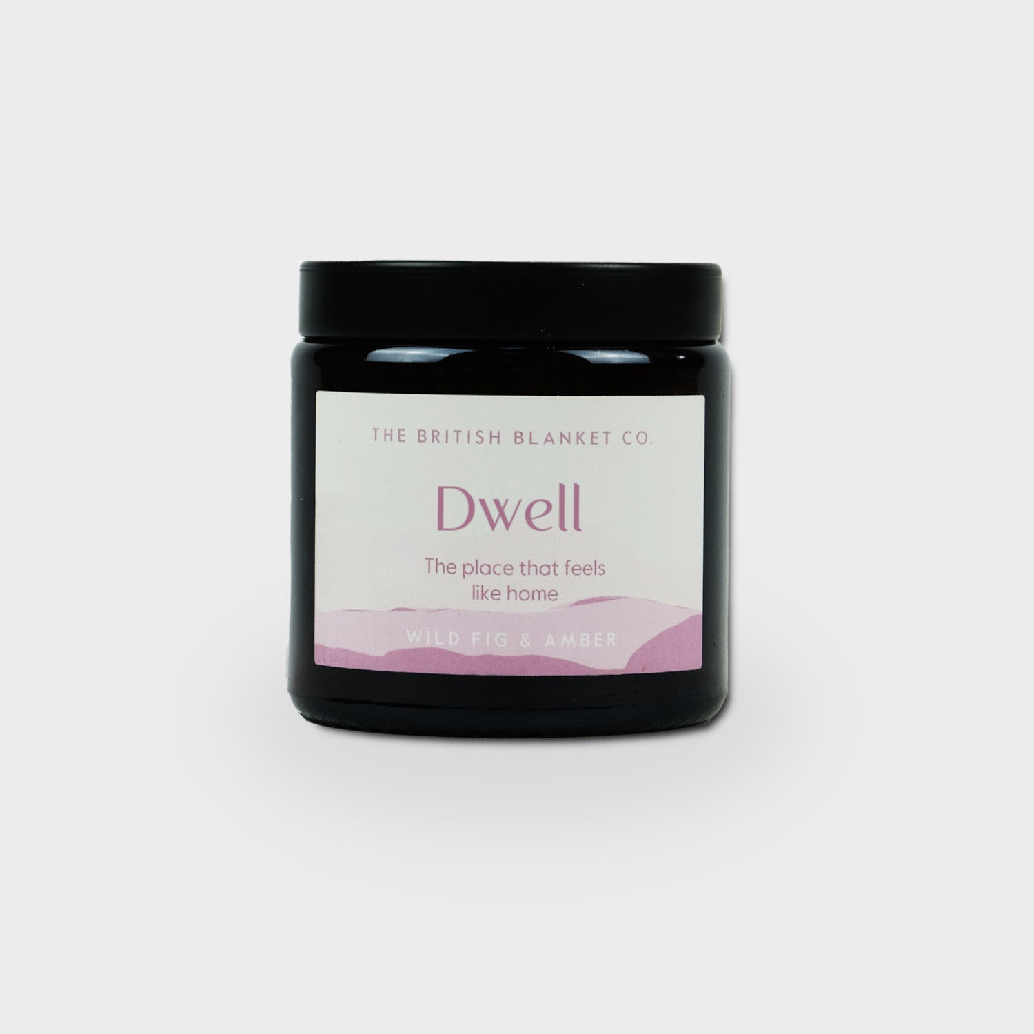 Amber Jar Candle by The British Blanket Co., black jar with purple label, embodies Wild Fig & Amber scent, hand-poured in Wiltshire with natural soy wax.