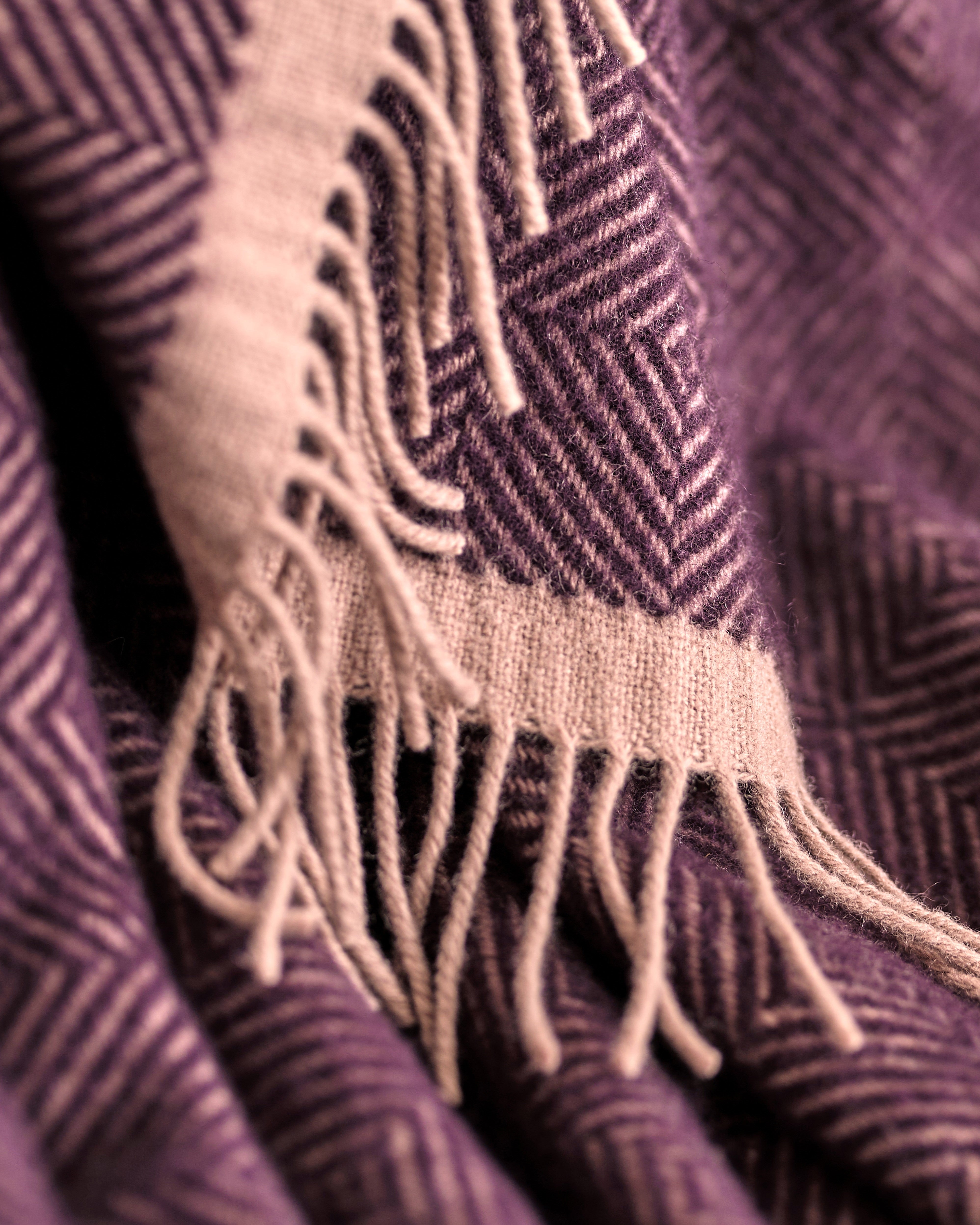 Wildweave Blanket Gift Box: Blackberry & Heather, featuring a soft wool blanket with a purple-and-cream herringbone pattern and fringe, perfect for cozy gifting.