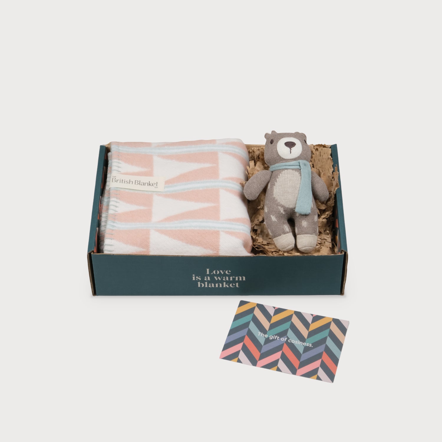 Cloud Cotton Baby Blanket Gift Box: Harmony Blossom contains a geometric-patterned blanket, a knitted teddy bear with a scarf, and a colorful gift card in a themed box.