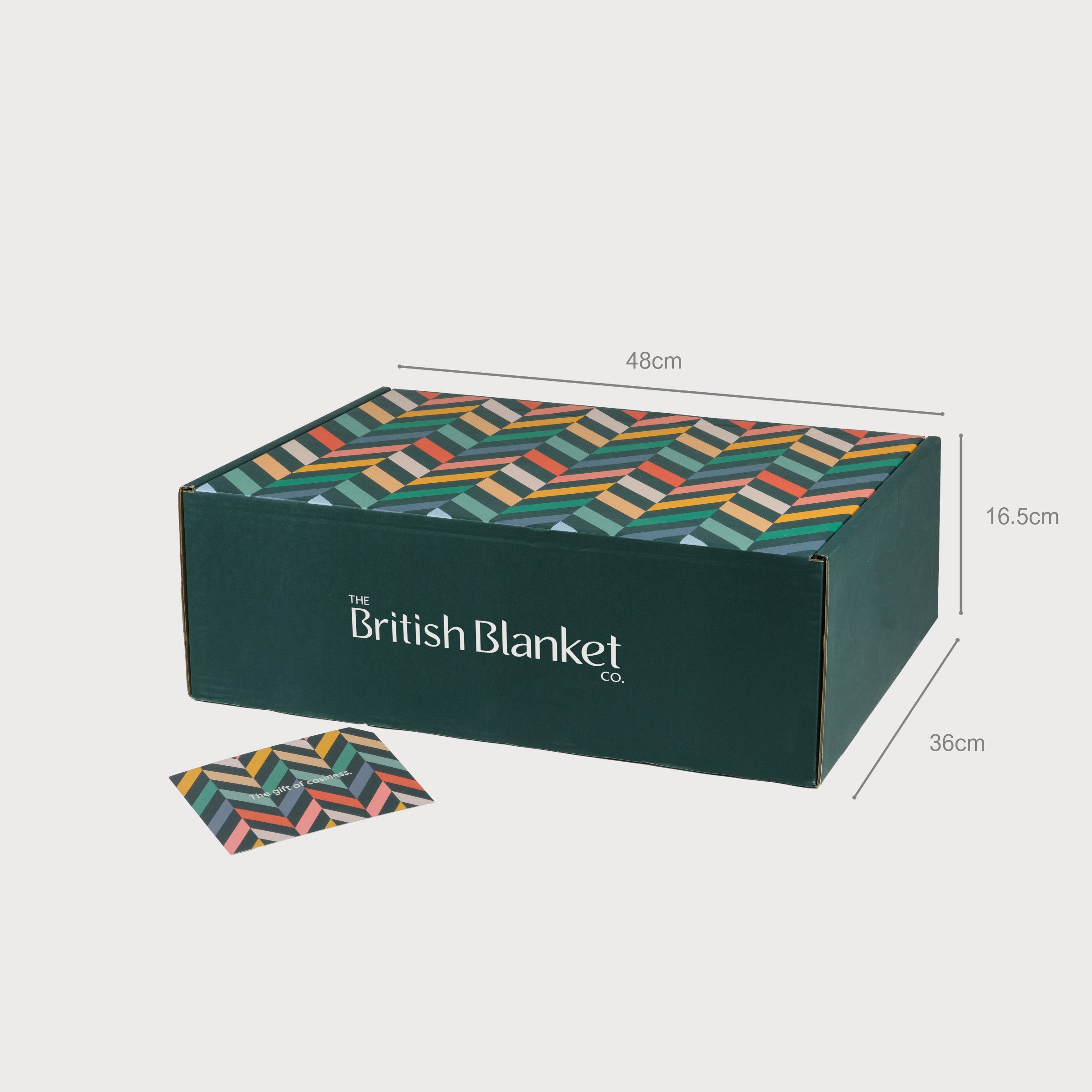 Wildweave Blanket Gift Box: Blackberry & Heather, featuring a dark-green box with chevron lid, matching card, and includes a wool blanket, candle, and chocolate.