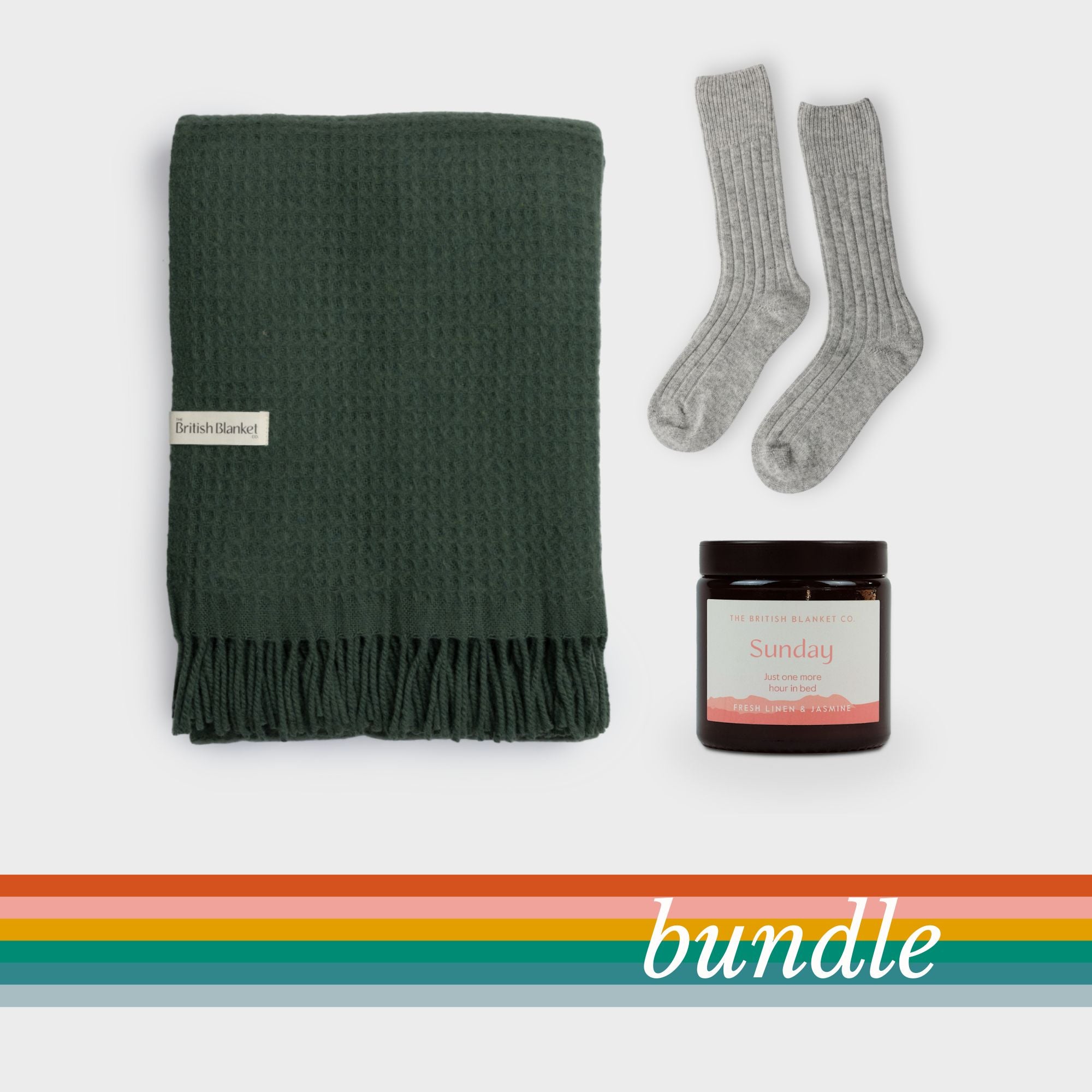 Bright Friday Blanket Bundle: College Green includes a dark-green throw, heather-gray socks, and a scented candle in a brown jar, perfect for gifting or self-care.