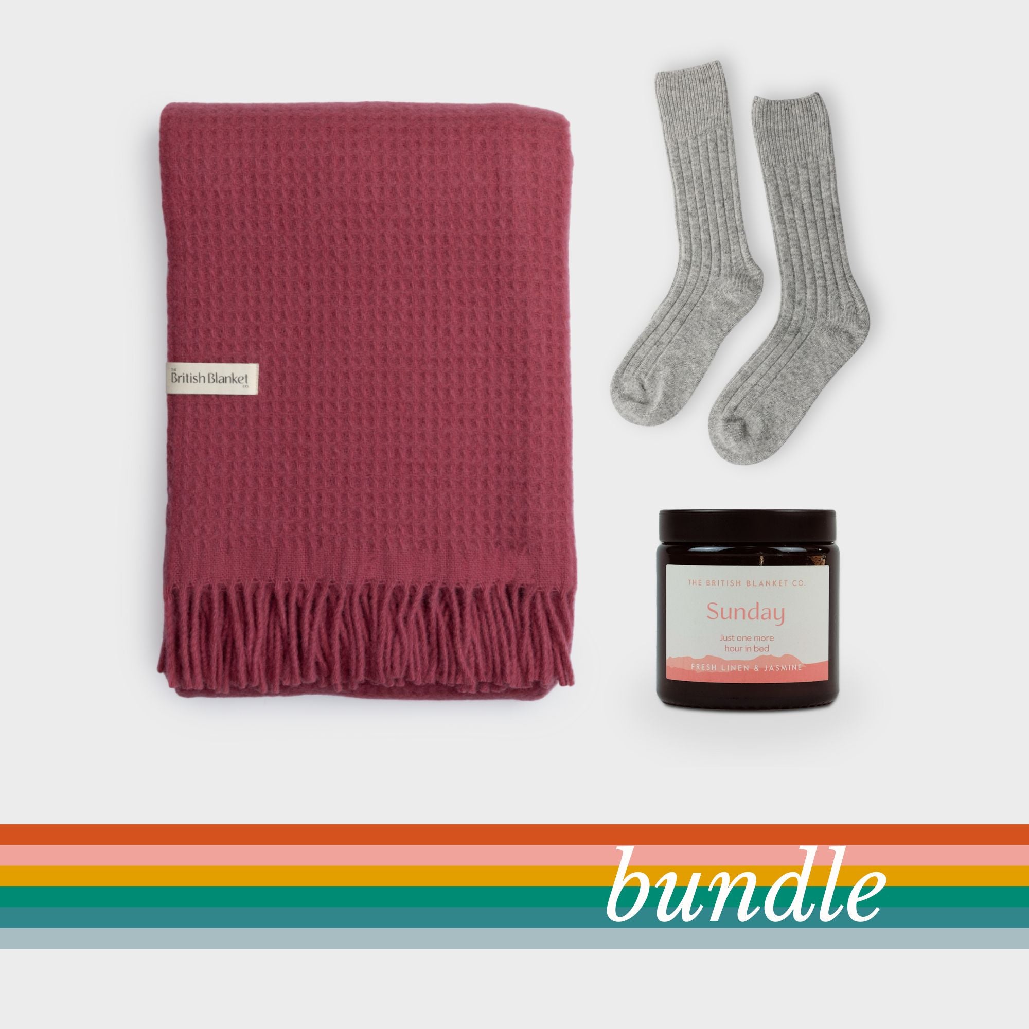 Bright Friday Blanket Bundle: Lush featuring a raspberry-red woven throw, grey ribbed socks, and a Sunday scented candle, perfect for cozying up.