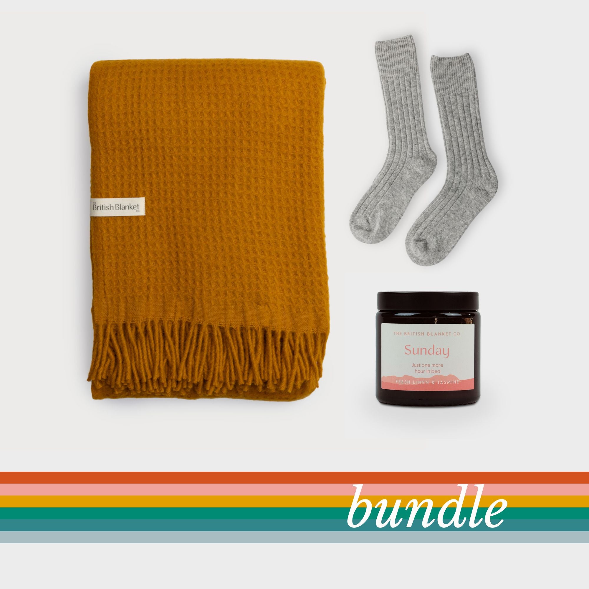 Bright Friday Blanket Bundle: Ashton features a mustard waffle blanket, grey wool socks, and a Sunday scented candle, laid out against a white background.