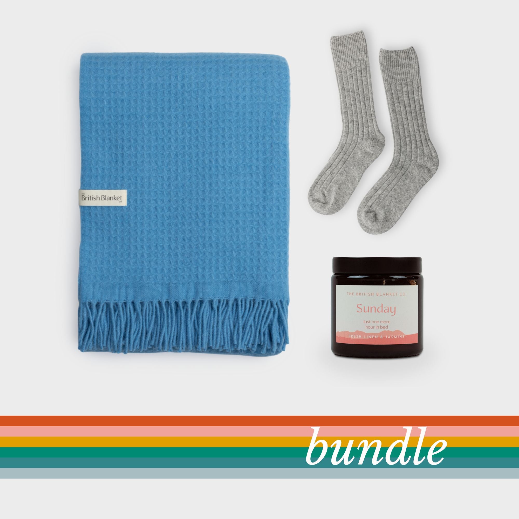 Bright Friday Blanket Bundle: Lido — includes a blue waffle-weave throw, light-grey ribbed socks, and a brown jar candle labeled Sunday. Perfect for cozy relaxation.