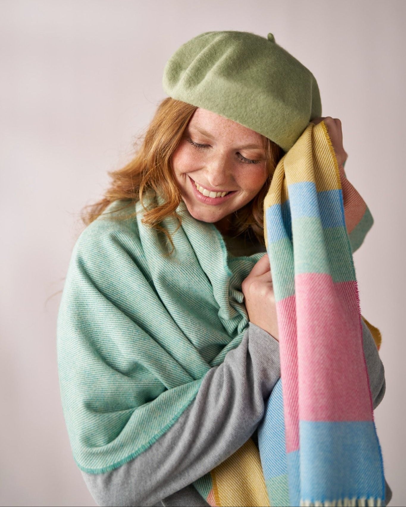 Young woman wearing a Wool Beret Hat: Light Green, crafted from thick premium wool, paired with cozy pastel scarves for a chic, relaxed look.
