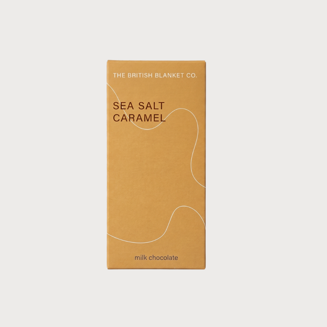 Chocolate Bar: Sea Salt Caramel (Milk) by The British Blanket Co., featuring minimalist tan packaging with a white line graphic.