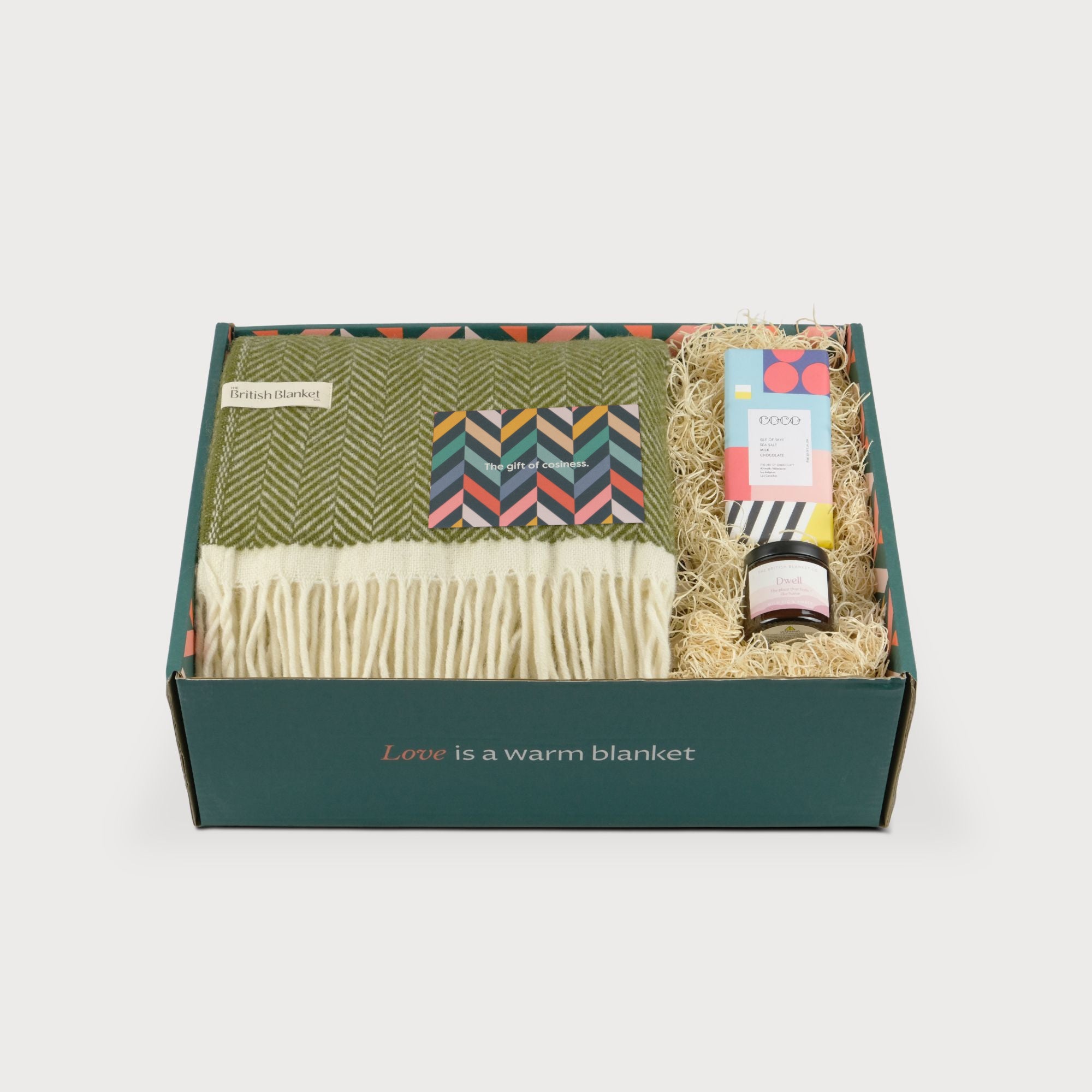 Blanket Hamper: Clifton Blaise featuring an olive-green herringbone wool blanket, artisan chocolate, preserves, all in a green box with Love is a warm blanket stamp.