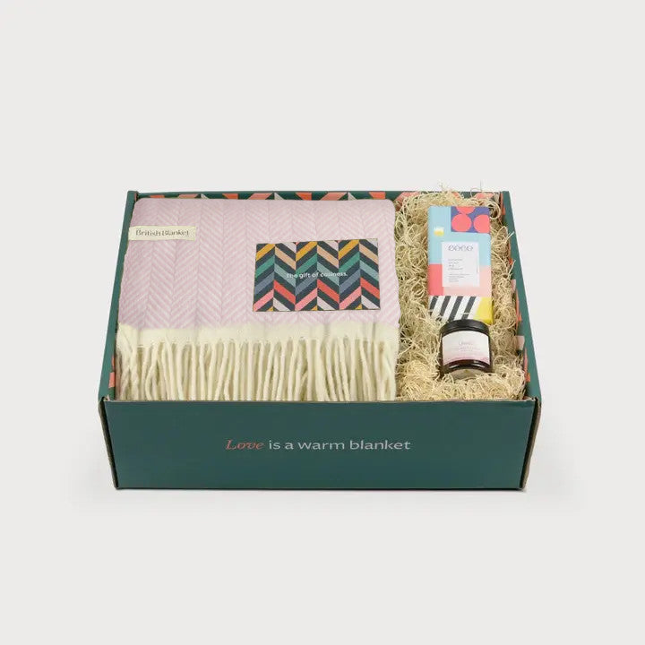 Clifton Blanket Hamper: Polygon features a cozy herringbone throw, specialty food bar, small jar, and decorative filling, perfect for gifting warmth and comfort.