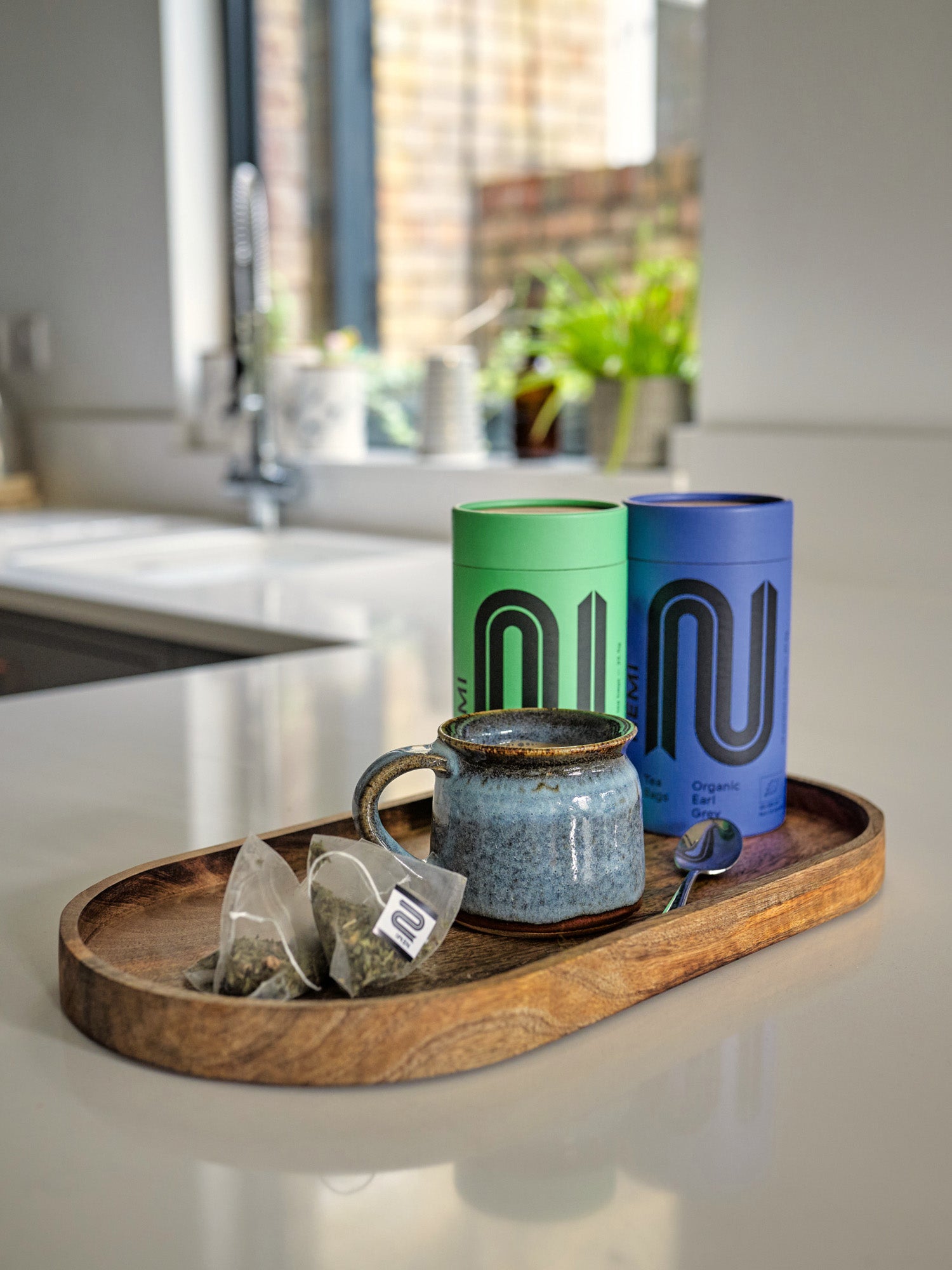 Luxury Organic Tea gift box with 15 compostable tea bags, featuring fair trade, organic ingredients like English Breakfast, Earl Grey, and Peppermint, promoting refugee employment.