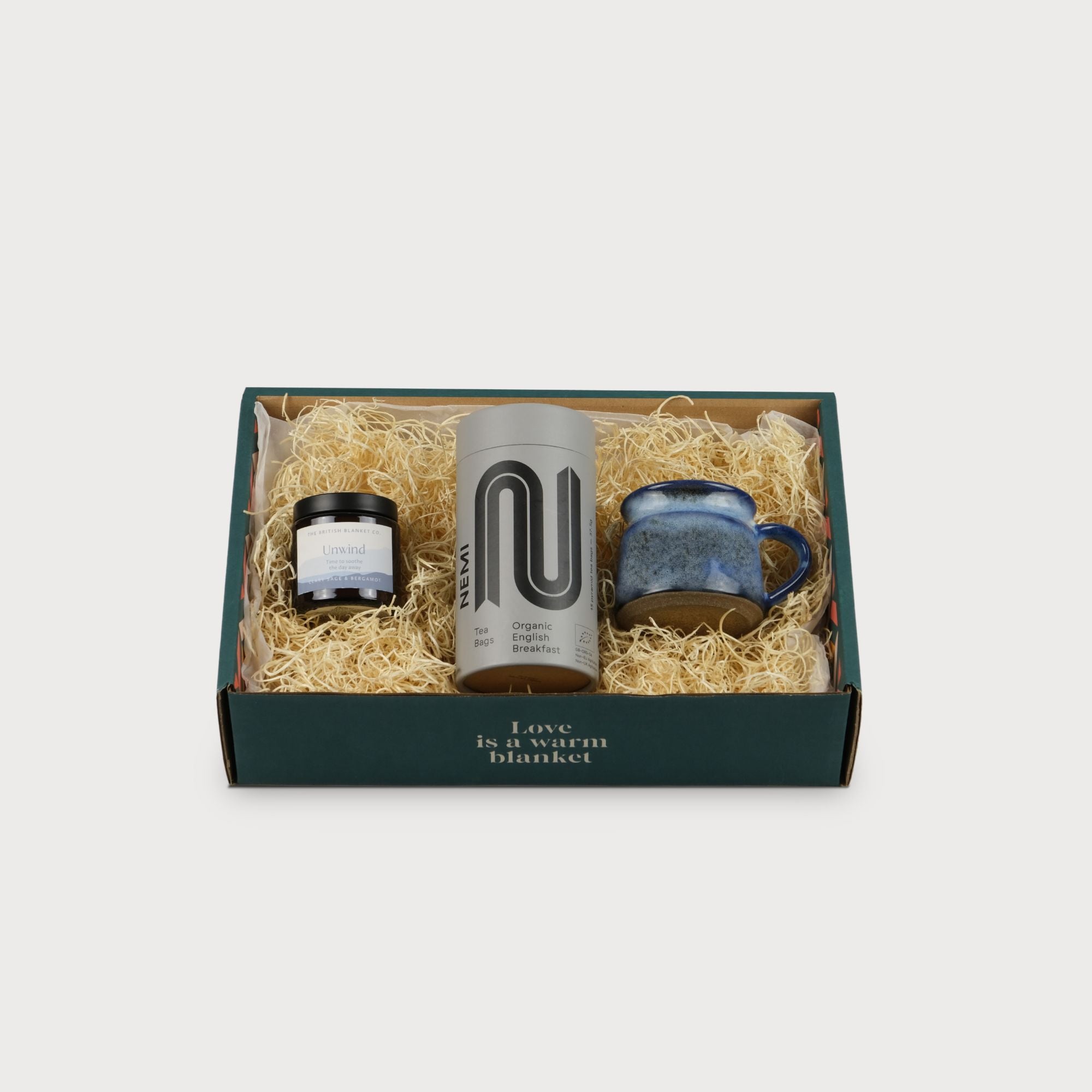 Cosy Gift Box: Tea Break featuring a box with white text, a close-up of a tea bottle, and a labeled jar for a perfect tea-lover's gift.