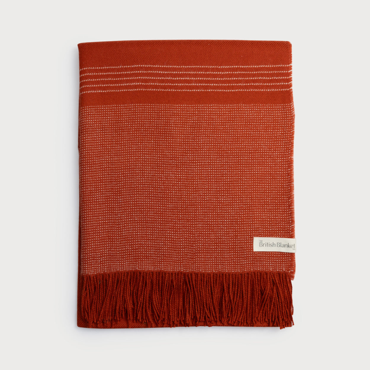 Alpaca Blanket Gift Box: Flame Orange with rust-coloured woven blanket, white stitch details, fringed bottom, and “The British Blanket Co.” label.