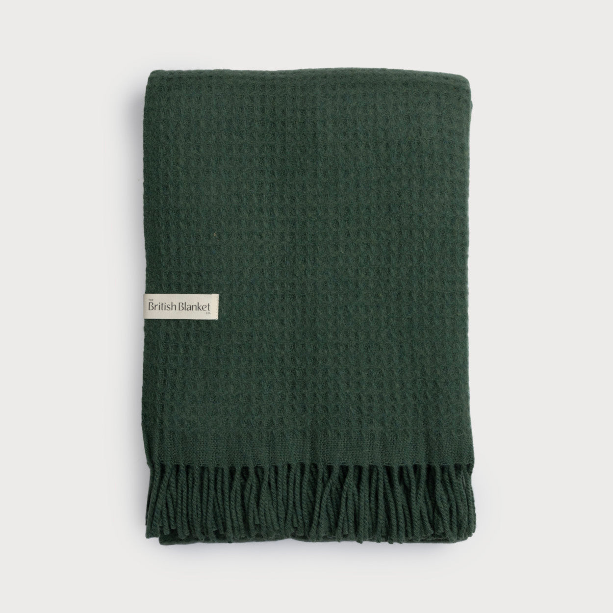 Bright Friday Blanket Bundle: College Green, featuring a waffle-weave texture, fringe edge, and “The British Blanket Co.” tag, neatly folded for display.