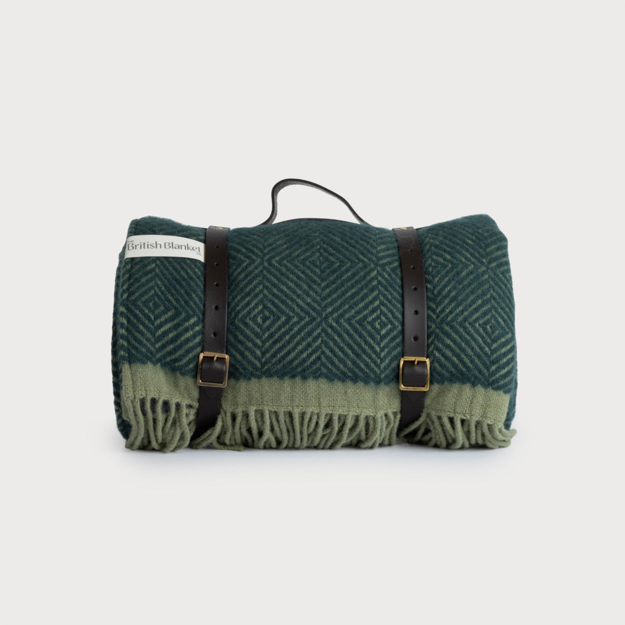 Waterproof Picnic Blanket: Juniper and Moss, featuring a deep green wool texture with leather straps and buckles, ideal for outdoor use.