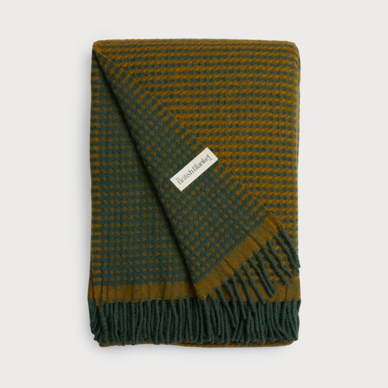 Totterdown Waffle Blanket: College Green & Ashton, showcasing a bold, reversible design with a deep waffle weave, crafted from pure sheep's wool for warmth and style.