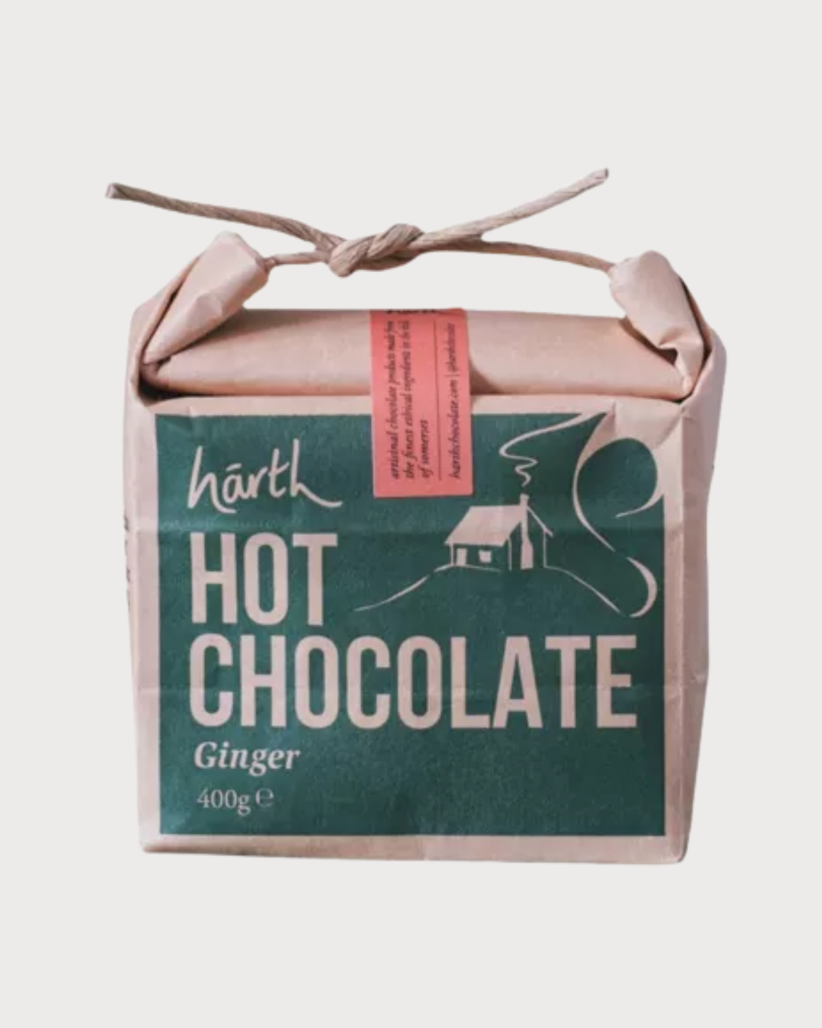 Christmas Blanket Gift Box: Polygon featuring a 400 g block of hārth ginger hot chocolate, wrapped in kraft paper with a green label and cabin illustration.