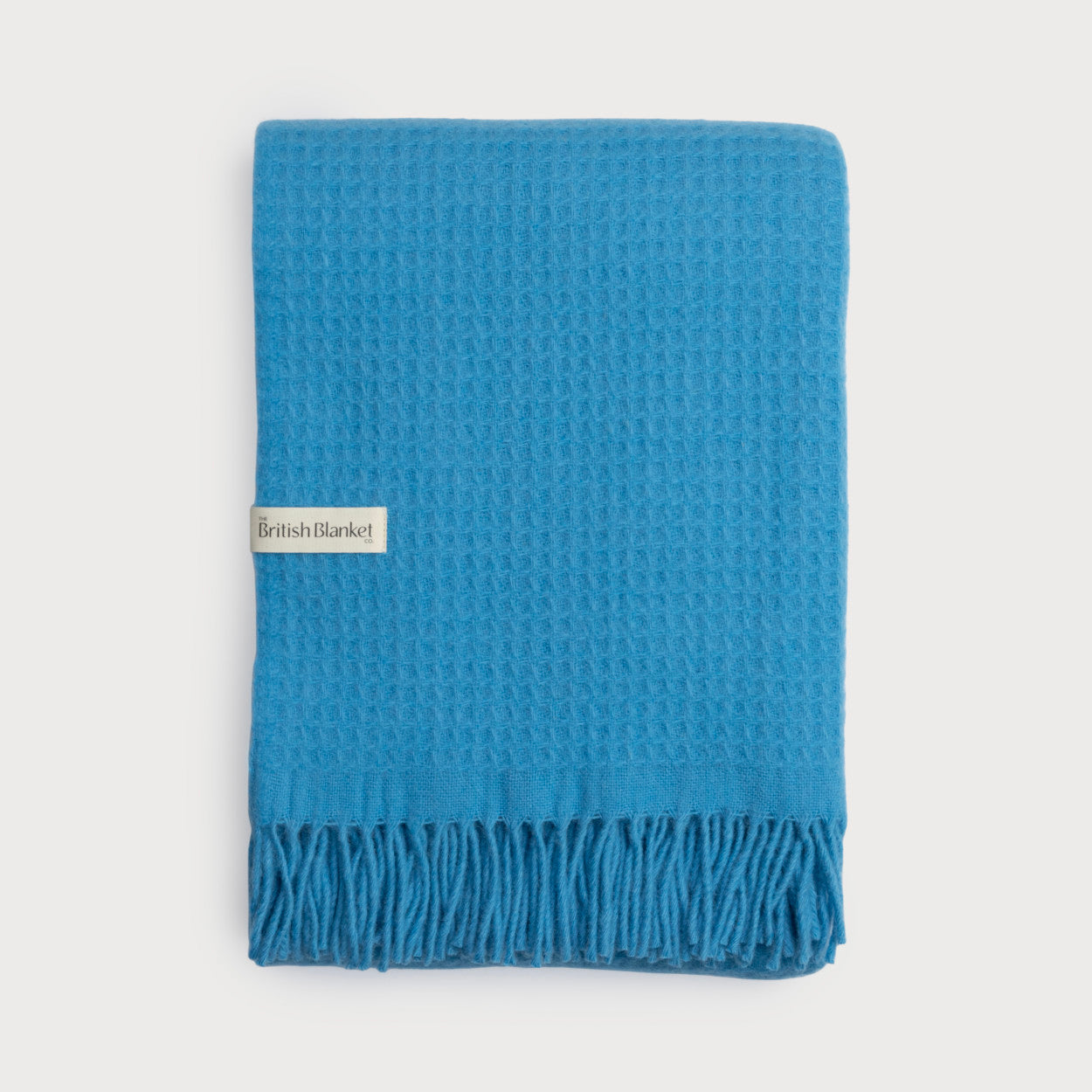 Bright Friday Blanket Bundle: Lido features a waffle-textured, lightweight throw with fringe and a British Blanket label, showcasing craftsmanship and style.