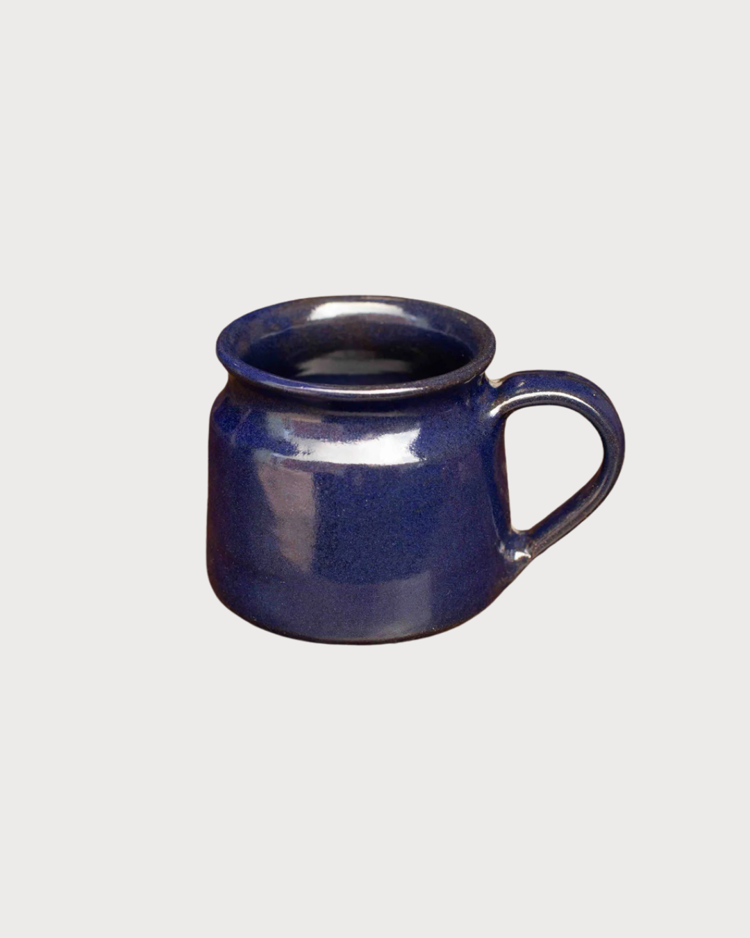 Cosy Gift Set: Get Comfy features a small, squat ceramic mug with a single handle, showcasing a deep blue glossy glaze, ideal for tea enthusiasts.