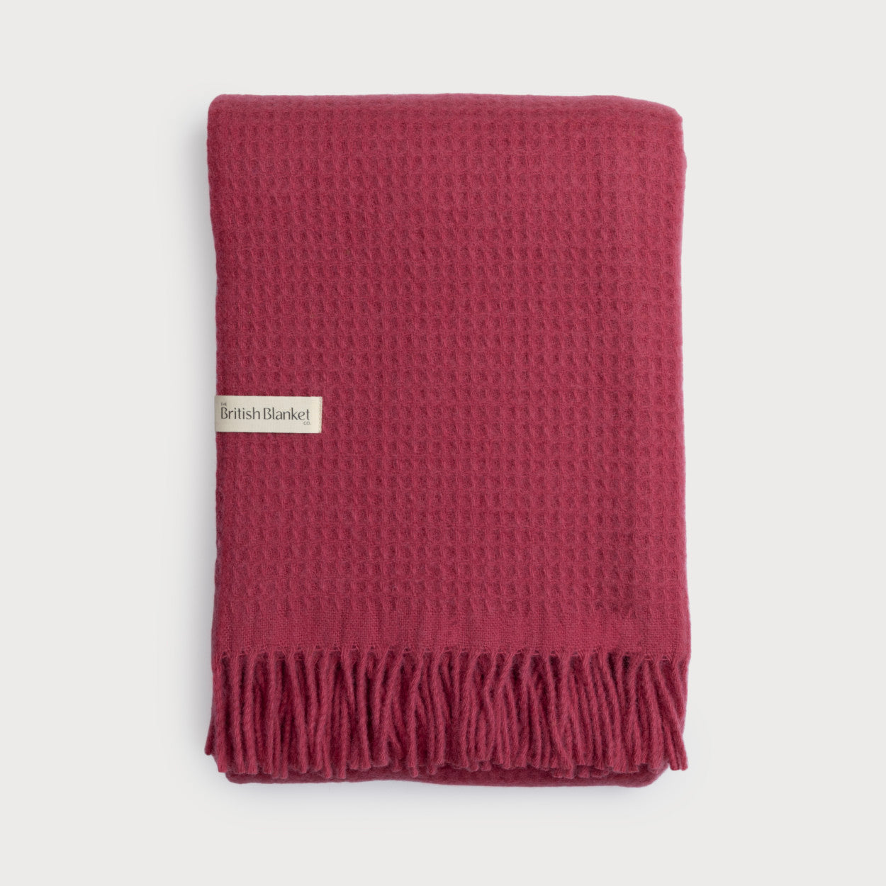 Bright Friday Blanket Bundle: Lush — Folded wool blanket with waffle-weave texture, fringed edge, and British Blanket Co. label, laid on a light background.