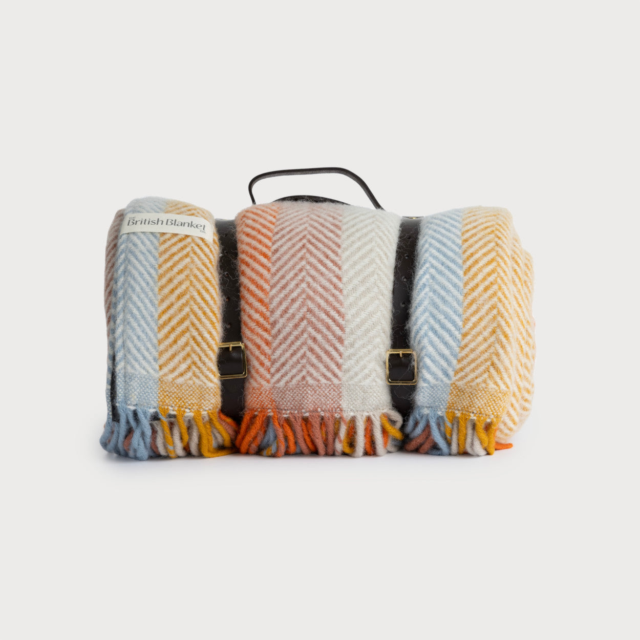 Waterproof Picnic Blanket: Boho, draped over a bag, with leather straps and a waterproof backing, ideal for outdoor use.