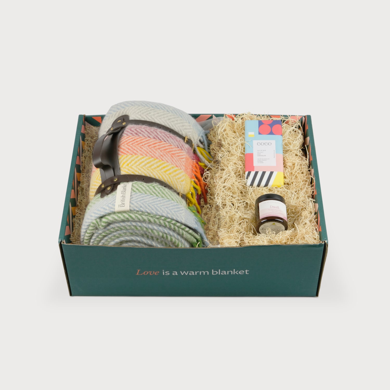Picnic Blanket Gift Box: Rainbow Bright features two wool blankets with leather straps, a colorful chocolate bar, and a jar, all in a forest-green box.