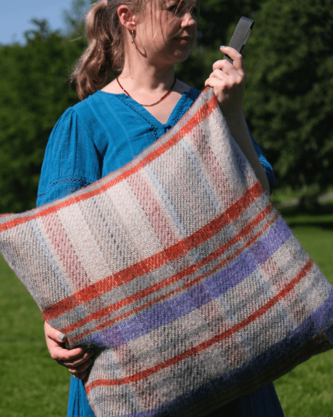 Random Picnic Pillow being held by a person in the park