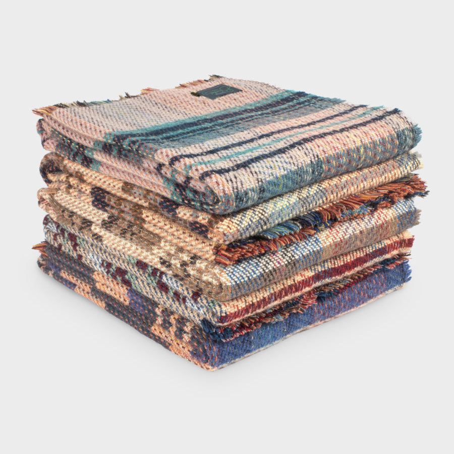 Random Recycled Blanket Hamper featuring a neatly stacked assortment of blankets, showcasing texture and craftsmanship, ideal for eco-conscious comfort and style enthusiasts.