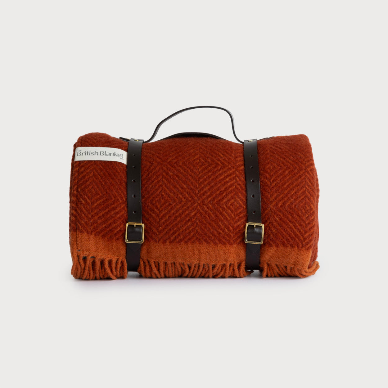 Waterproof Picnic Blanket: Rowan and Beech, featuring leather carry straps and a waterproof backing, neatly rolled and secured with a leather strap.
