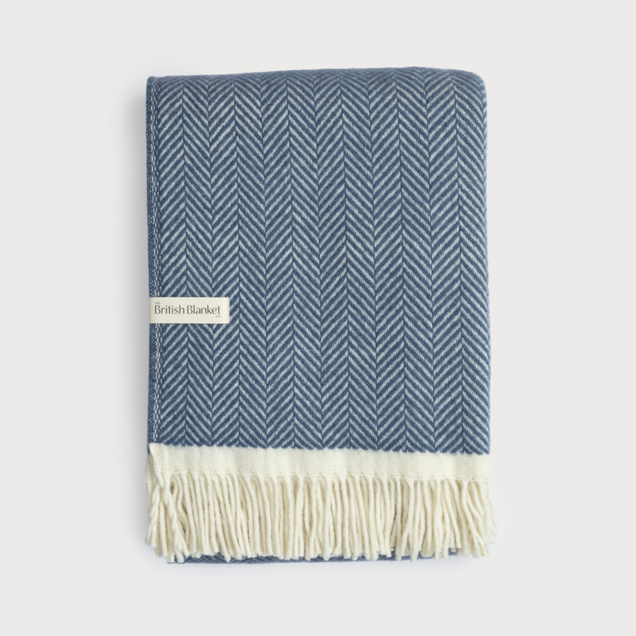 Clifton Blanket Hamper: Steamship, a woven throw with a herringbone pattern, features fringe and a label from The British Blanket Co.