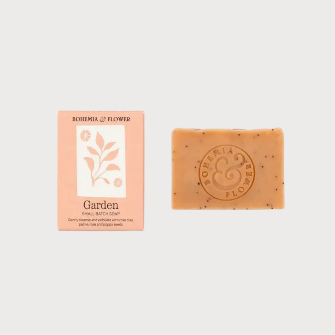Summer Garden Soap by Bohemia & Flower, featuring a speckled bar with logo, accompanied by matching soft peach packaging reading “Garden Small Batch Soap.”