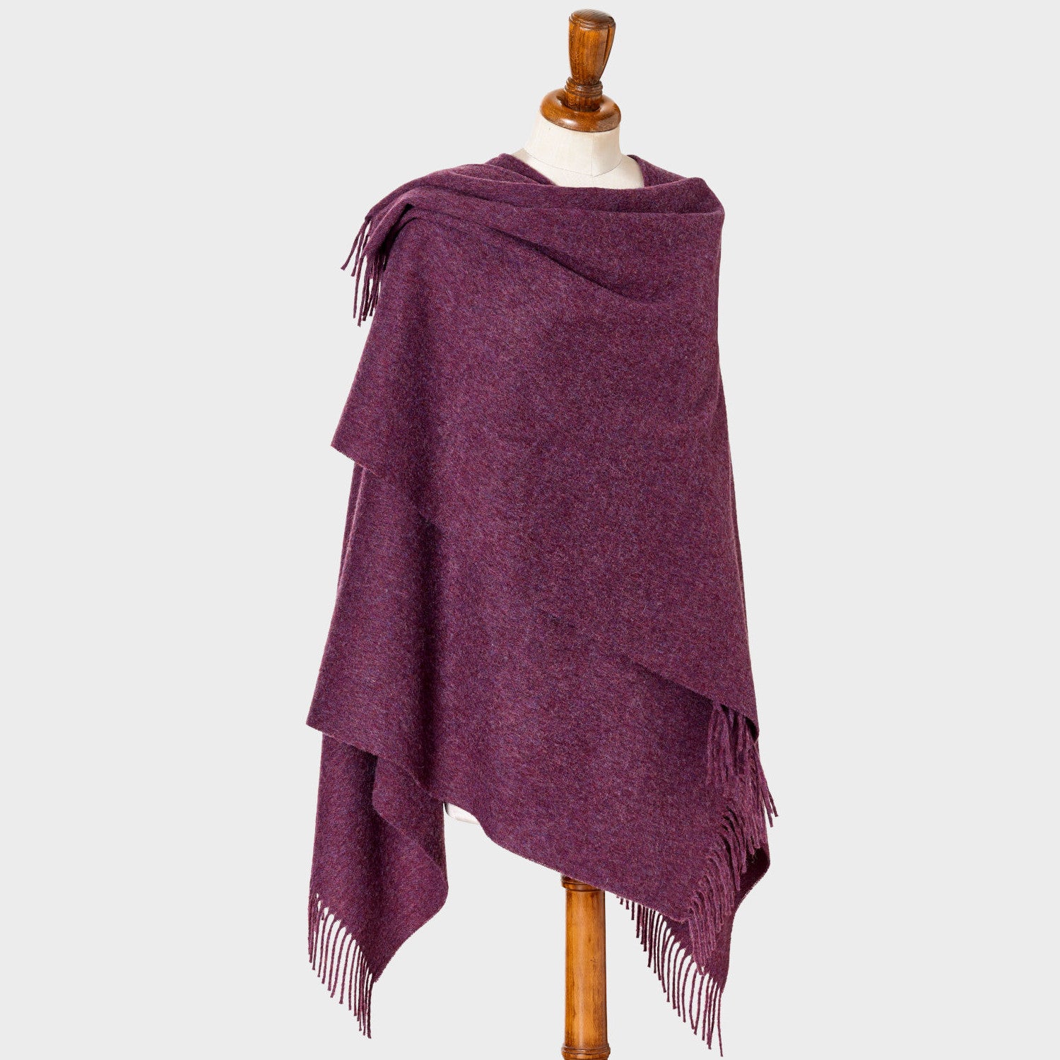 Heather Purple Wearable Blanket Wrap, made in Britain, drapes elegantly. Crafted from 100% Merino lambswool, it features a cut-out neckline and falls between hip and knee.
