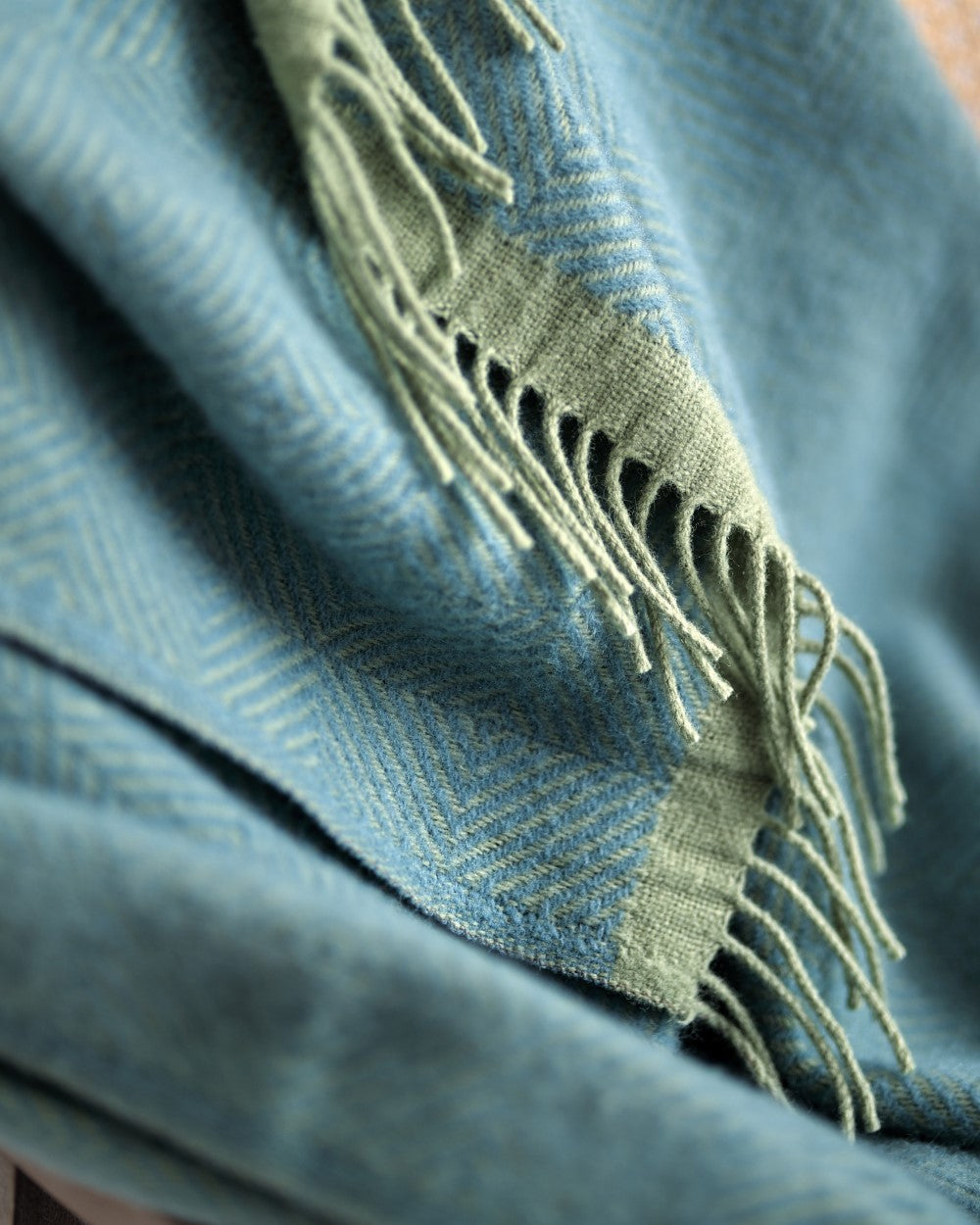 Wildweave Blanket Gift Box: Sea Holly & Lichen features a woven wool throw with a herringbone pattern and fringed edges, perfect for a cozy, thoughtful gift.