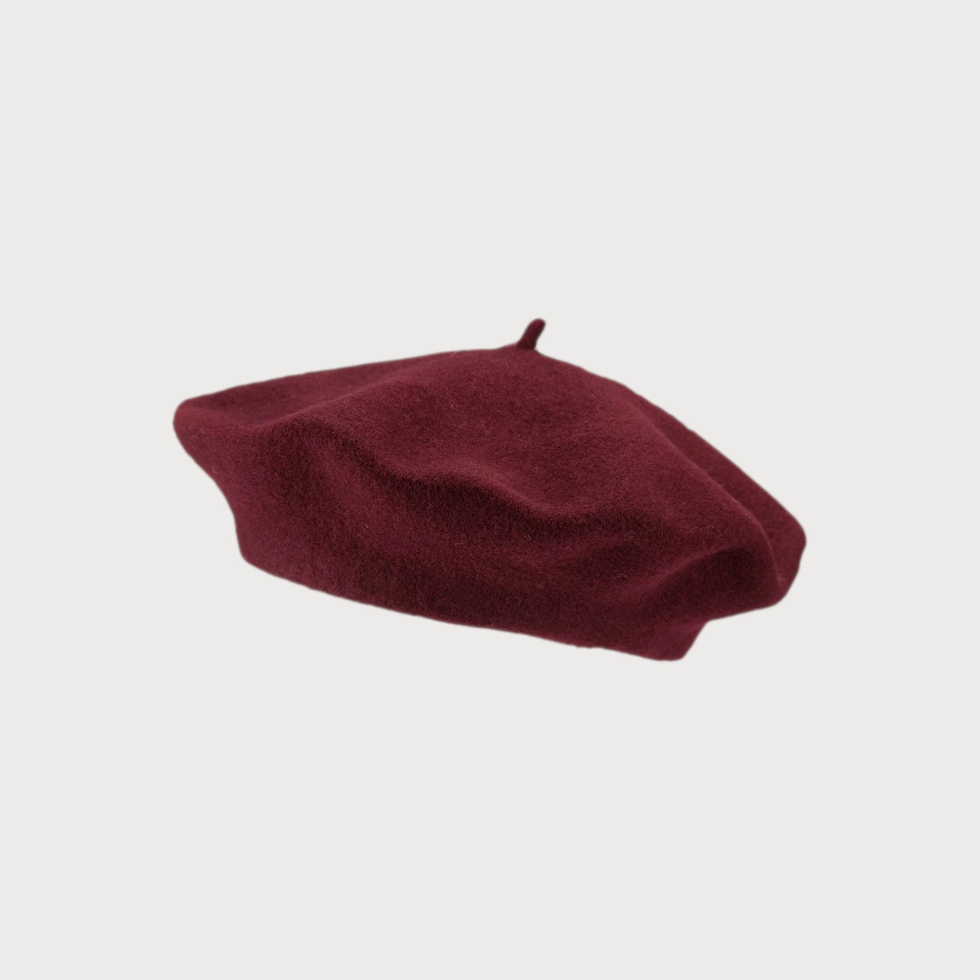 Wool Beret Hat: Burgundy, featuring a classic top stem, crafted from thick, high-quality wool felt for warmth and style; one-size fits most adults.