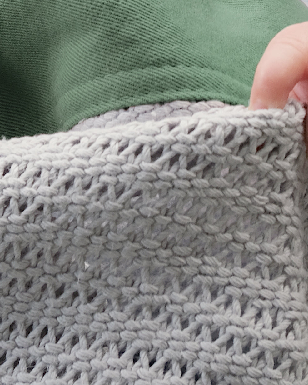 Organic Cotton Cellular Baby Blanket: Green, crafted at a British mill, showcases a breathable, lightweight design with contemporary trim, ideal for regulating baby's temperature.