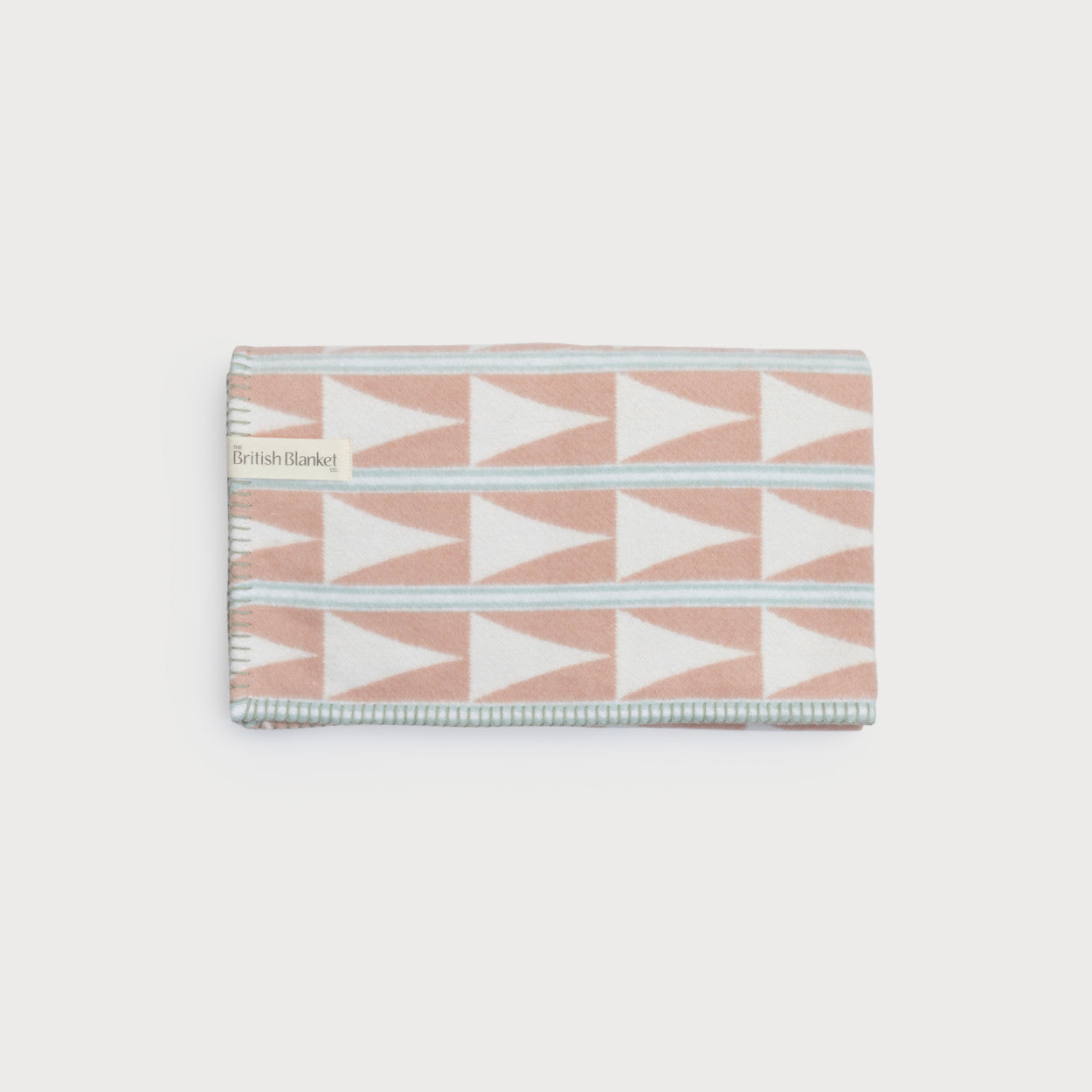 Cloud Cotton Baby Blanket Gift Box: Harmony Blossom, featuring a folded wool throw with triangular patterns and a “British Blanket” label in the corner.