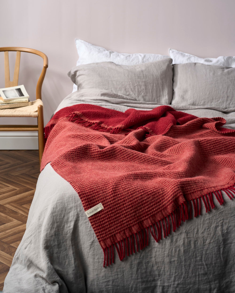 Totterdown Waffle Blanket: Air Balloon & Brunswick, displayed on a bed with a deep waffle weave, showcasing its reversible design and cozy texture.