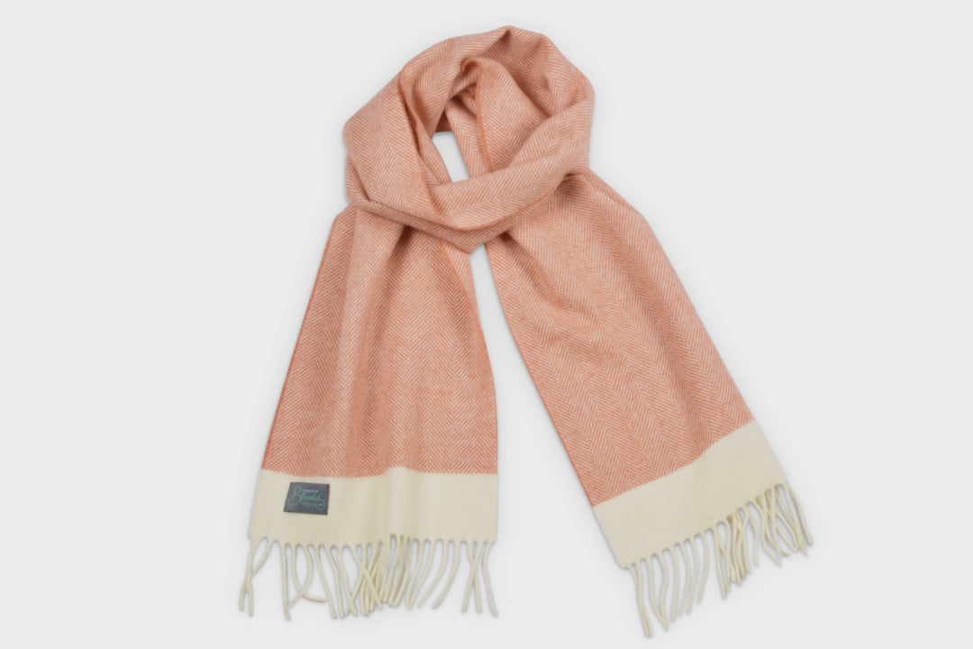 Orange and cream herringbone wool scarf by The British Blanket Company.