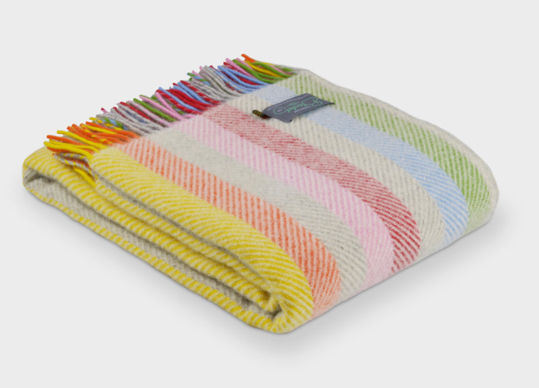 Folded large rainbow stripe herringbone wool throw by The British Blanket Company