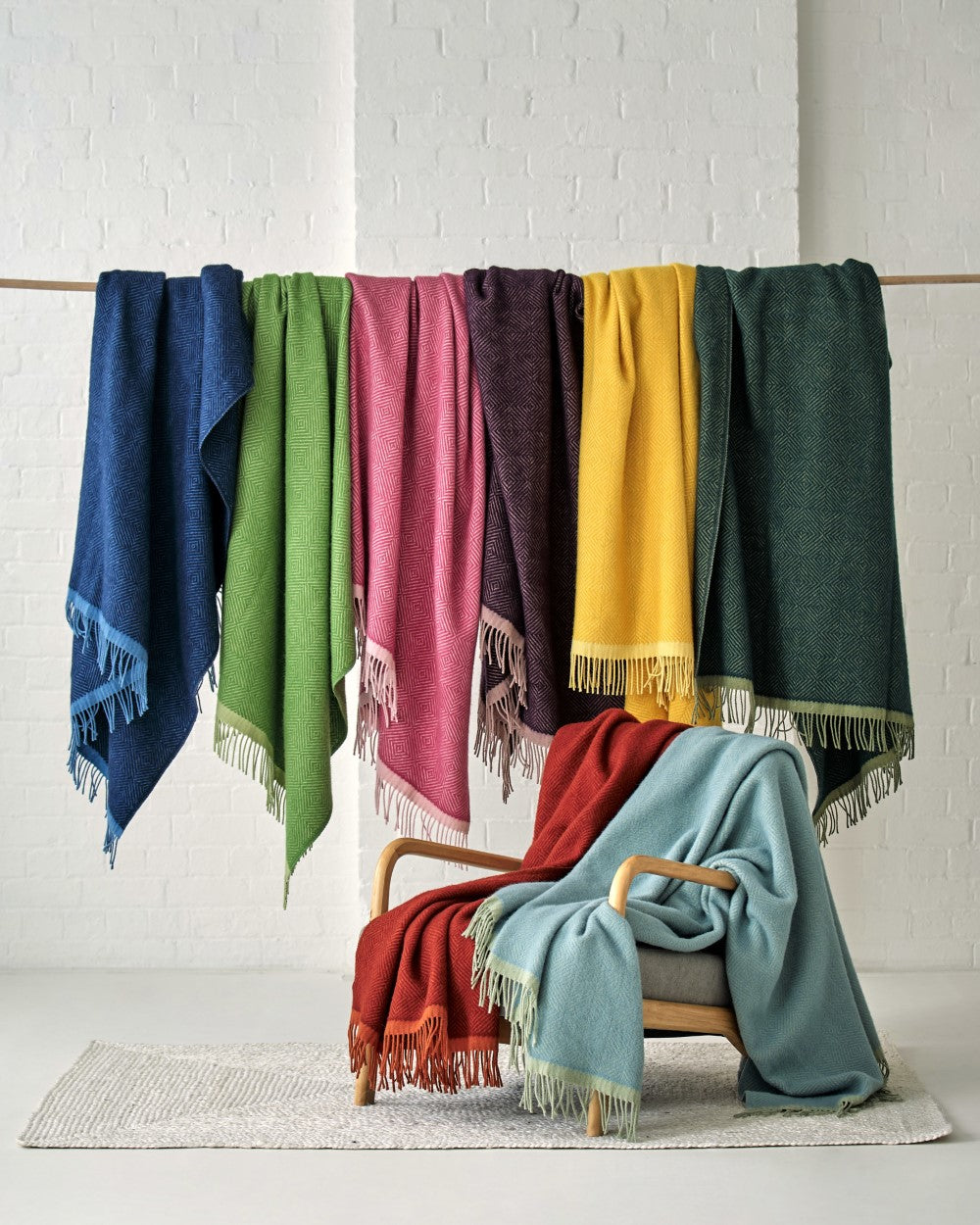 Wildweave wool blankets hanging and on chair