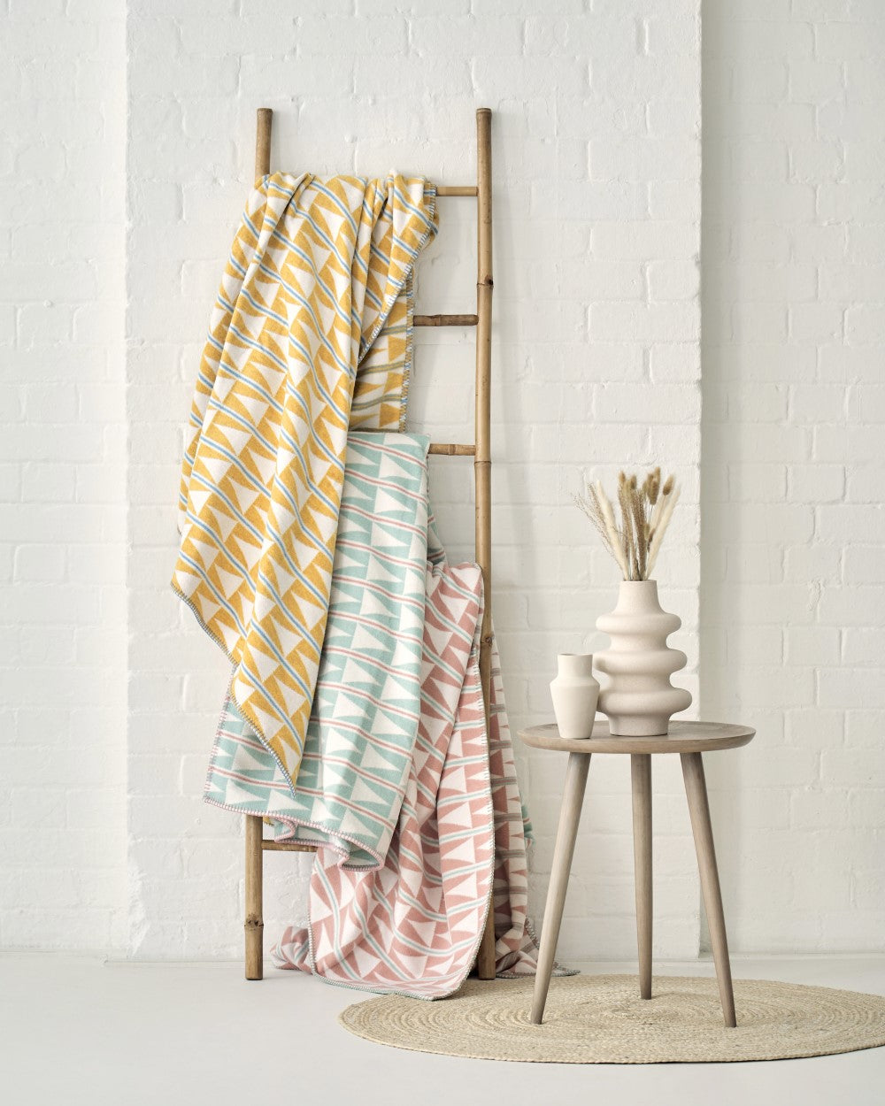 Cotton patterned blankets hanging on ladder