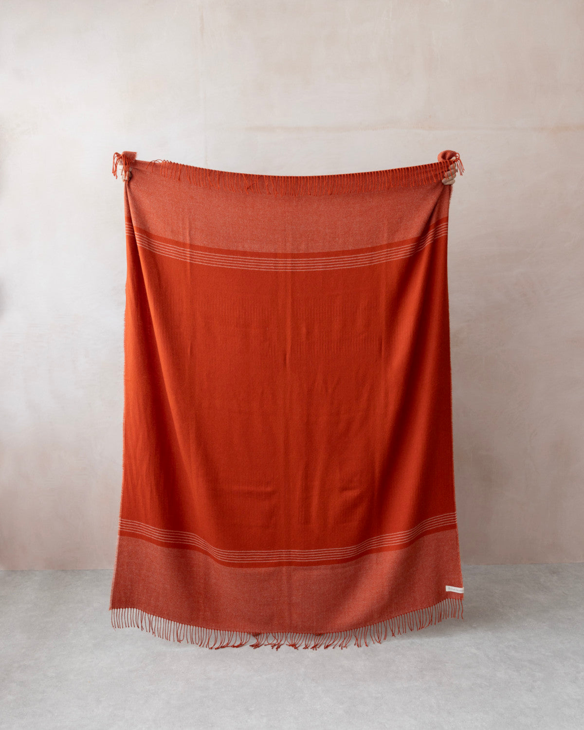 Alpaca Blanket Gift Box: Flame Orange features a rich orange-rust blanket with stripes and fringe, perfect for gifting with candle and chocolate.