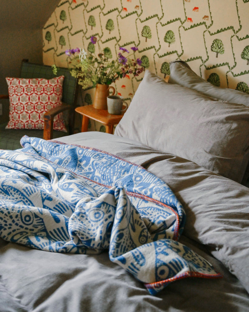 Rockpool in Blue from the Angie Lewin Special Edition Blanket Collection, lifestyle shot in a bedroom.