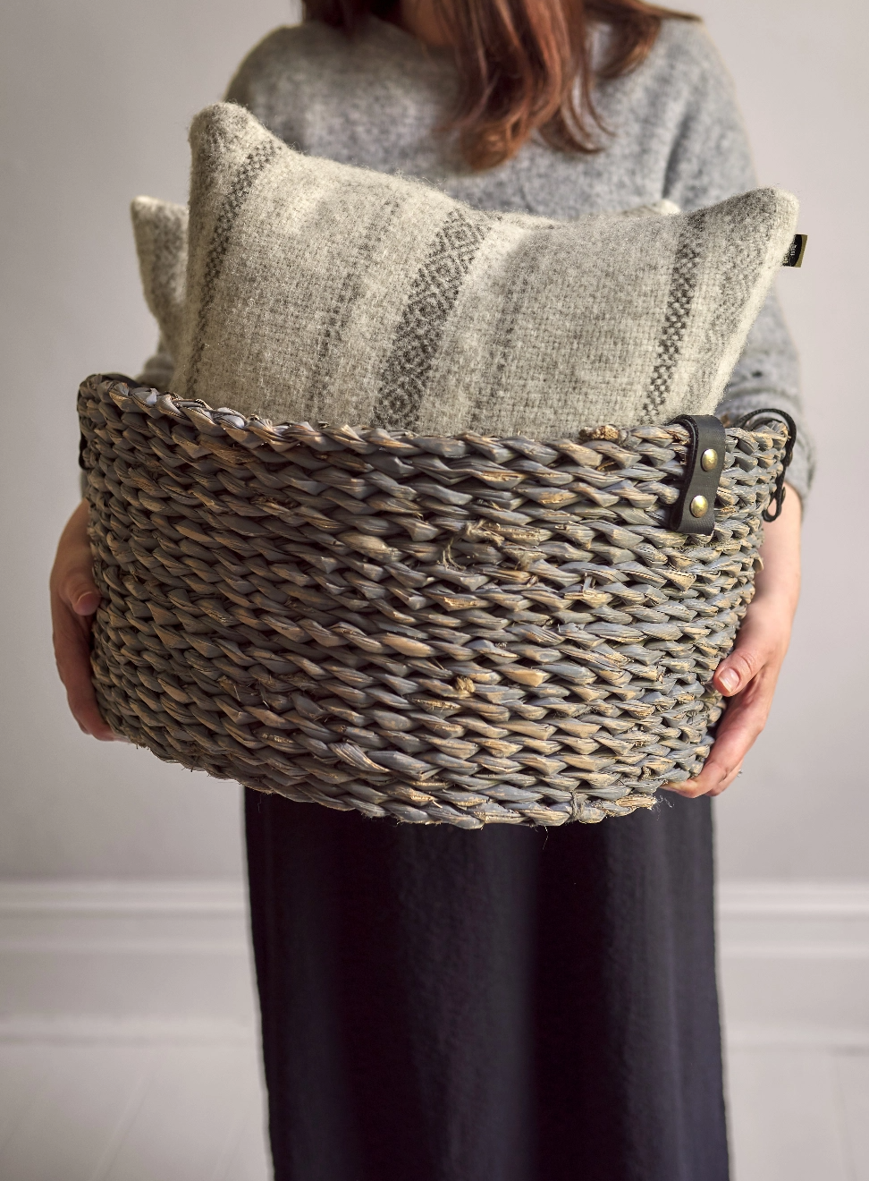 Person holding a basket with British Wool Cushions