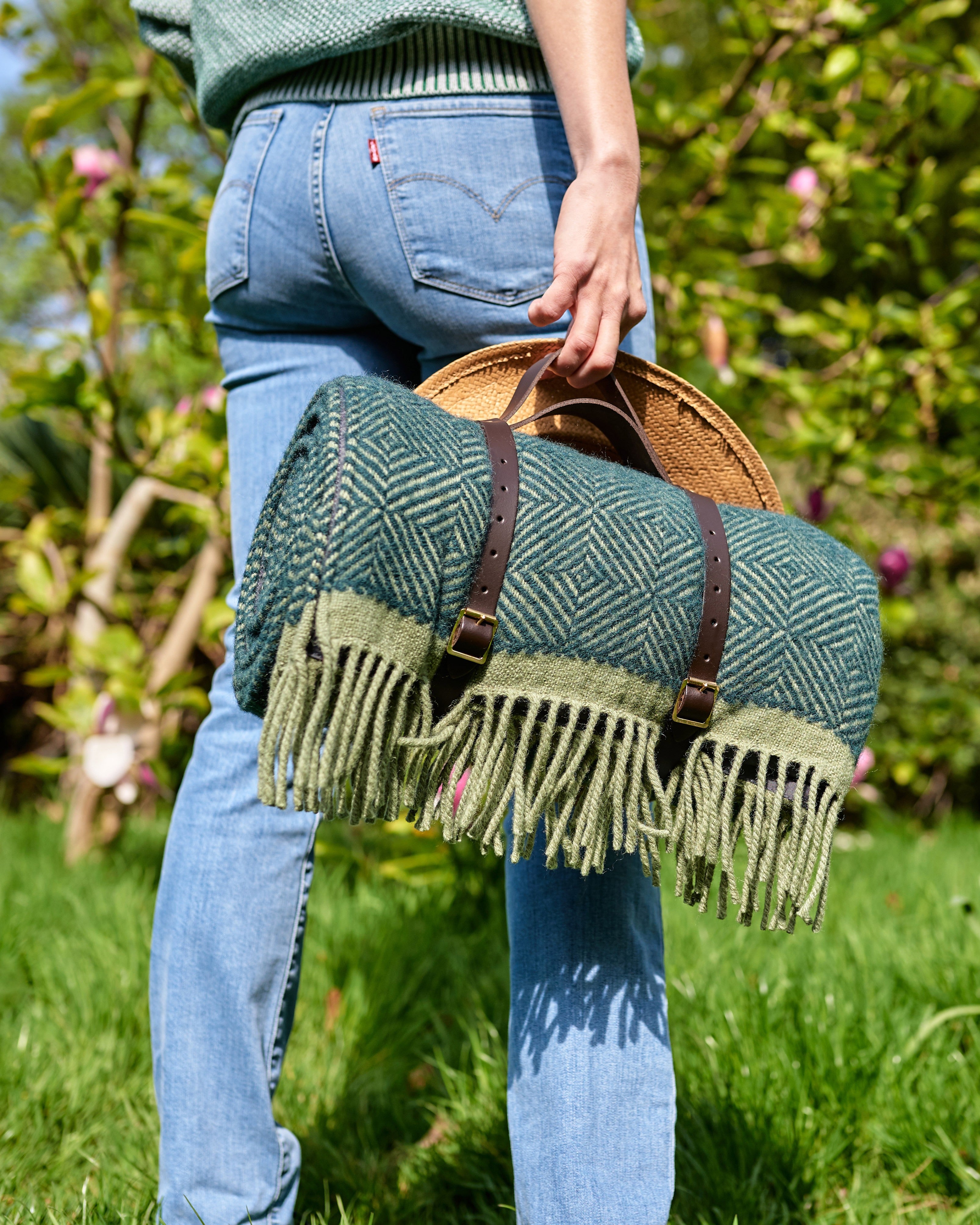 Waterproof Picnic Blanket: Juniper and Moss, featuring a handmade wool design with leather carry straps and a waterproof backing, ideal for outdoor use.