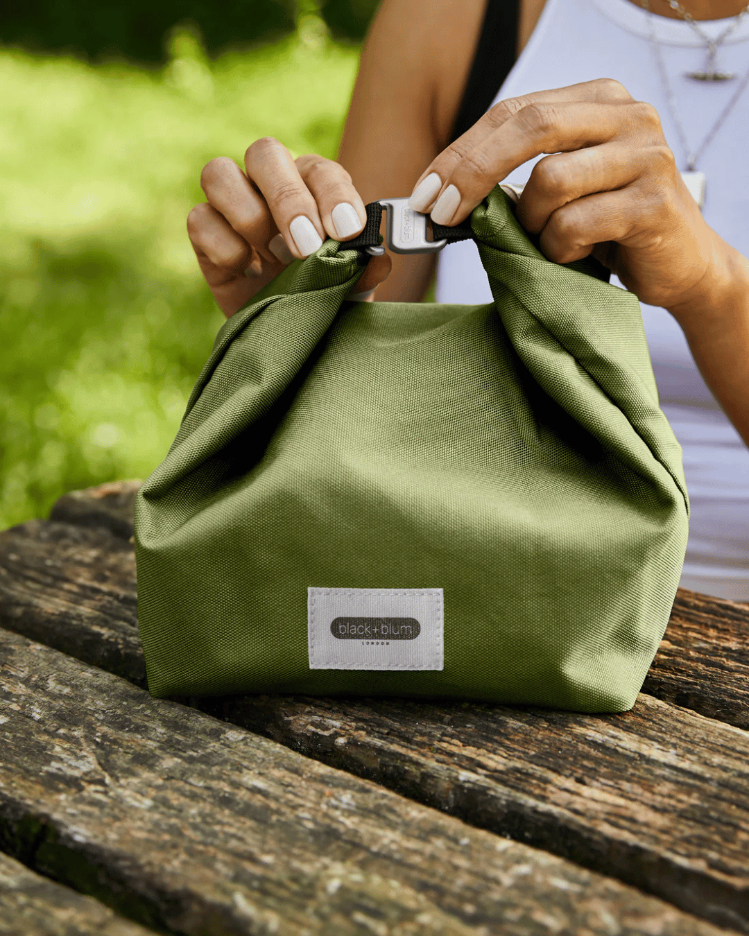Having lunch on a  picnic bench with the Black + Blum Lunch Bag
