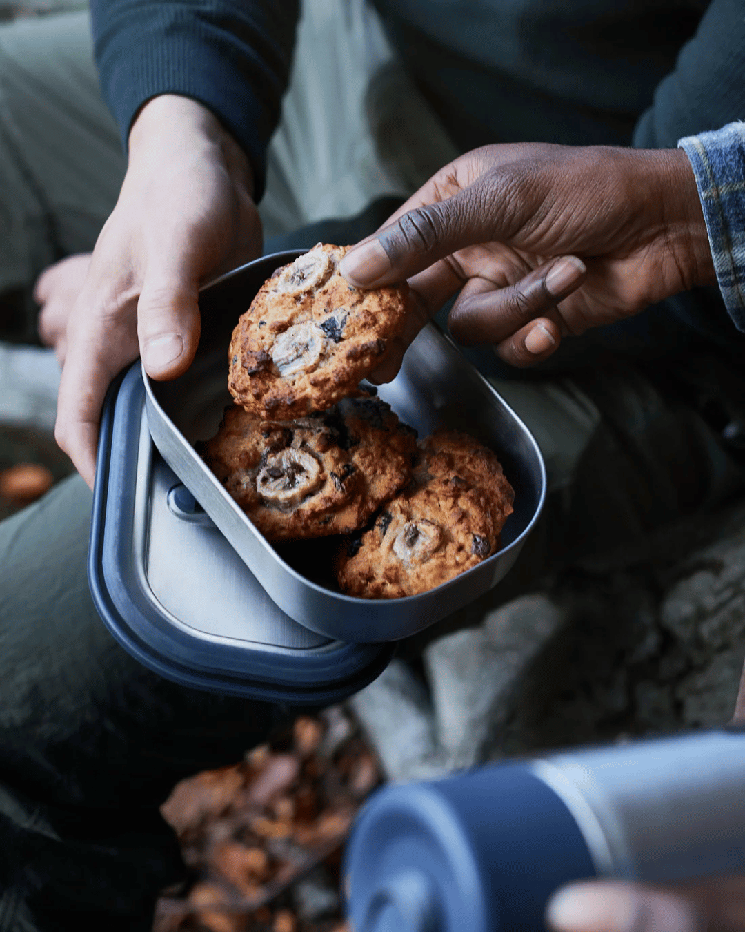 People sharing cookies from the Black + Blum Lunch Box